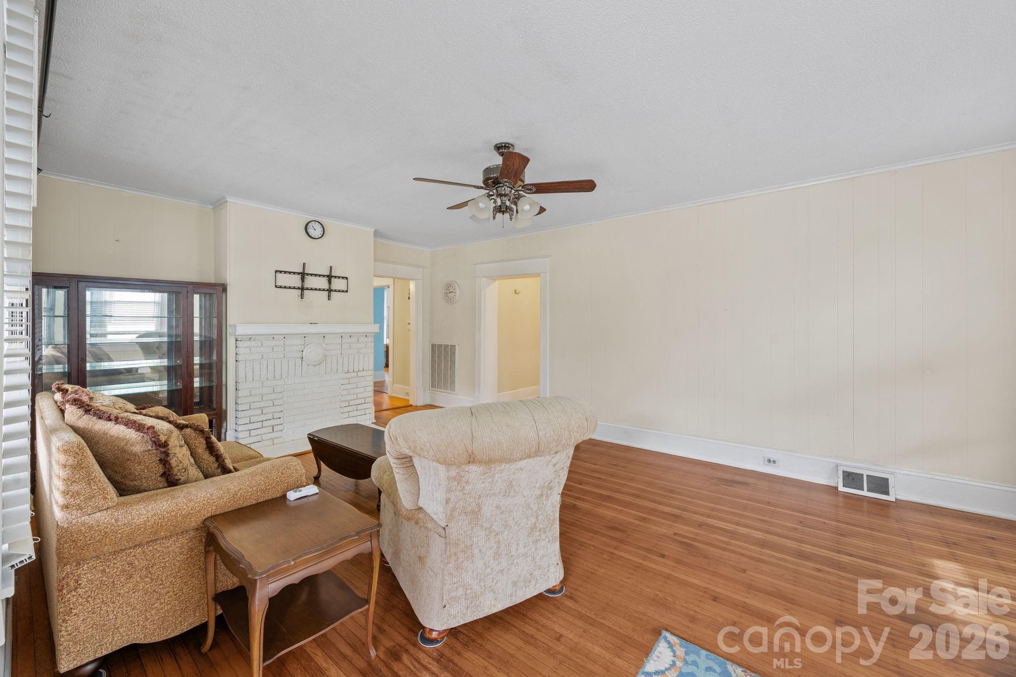 628 West Council Street Salisbury, NC 28144 - Photo 18 of 43 a living room with furniture and a chandelier