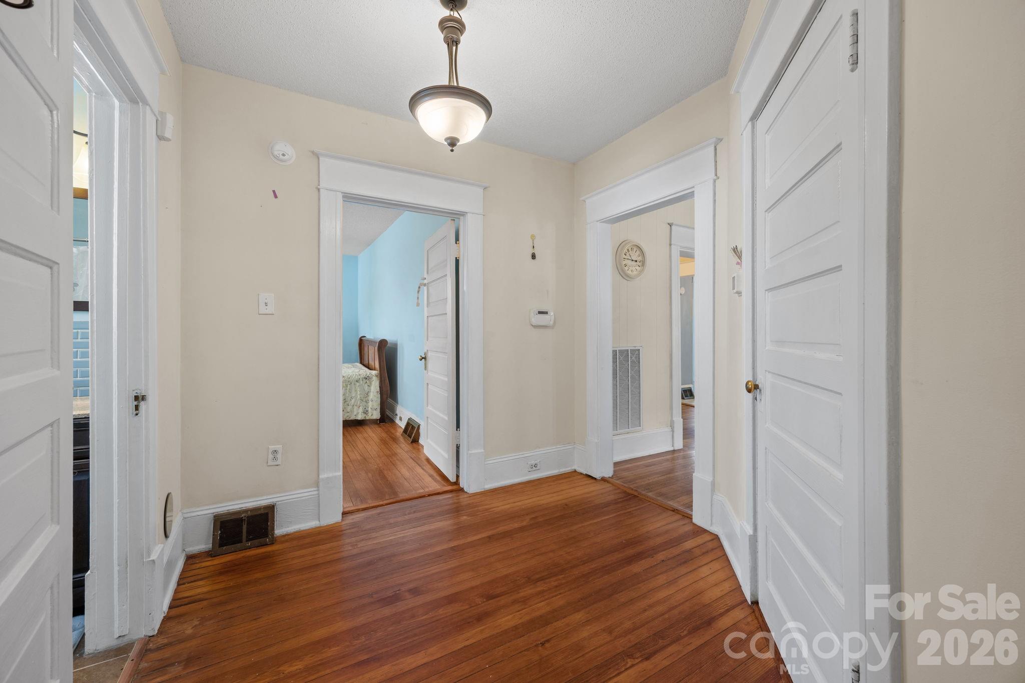 628 West Council Street Salisbury, NC 28144 - Photo 22 of 43 a bedroom with a bed and a chandelier