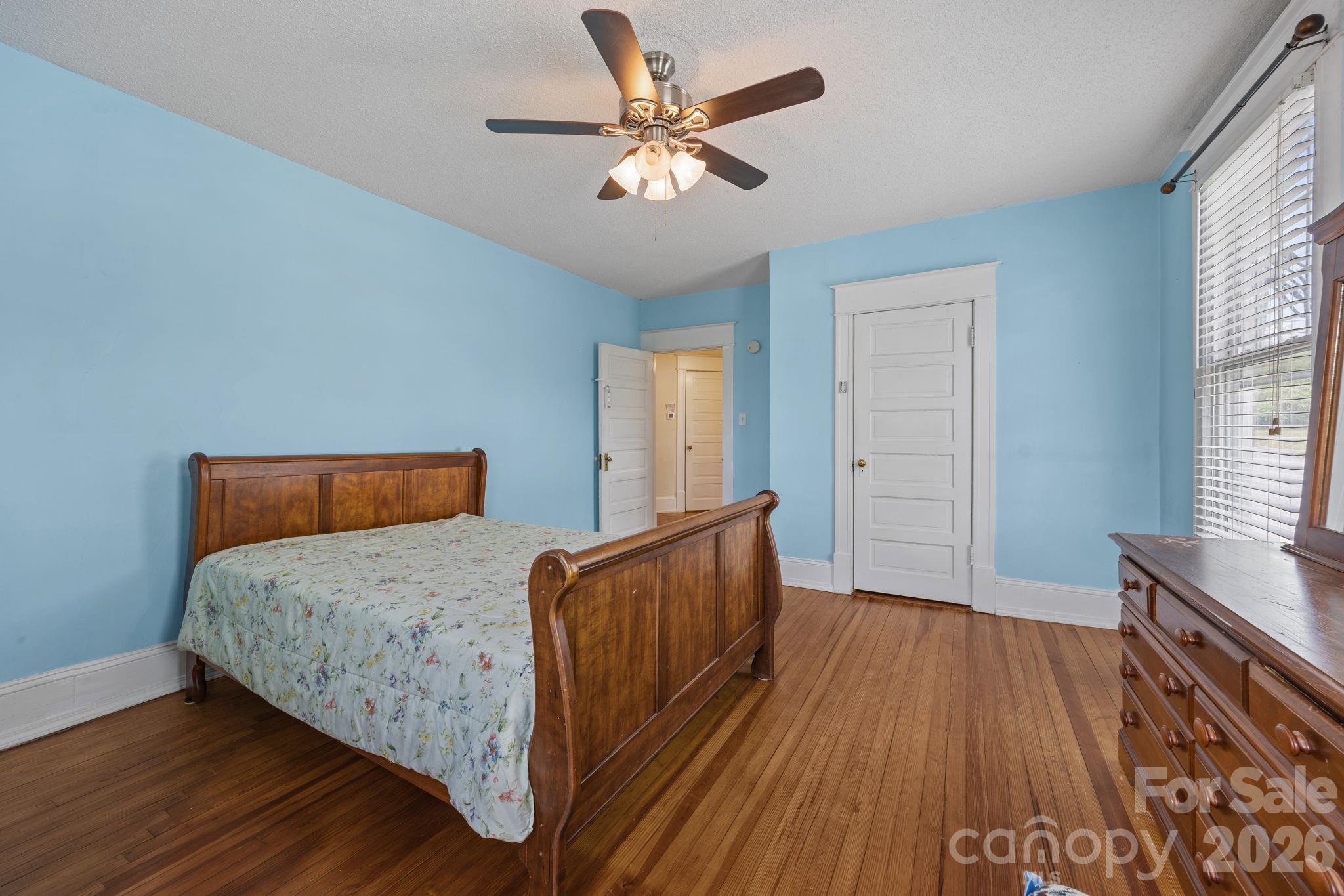 628 West Council Street Salisbury, NC 28144 - Photo 24 of 43 a bed room with a bed and a chandelier