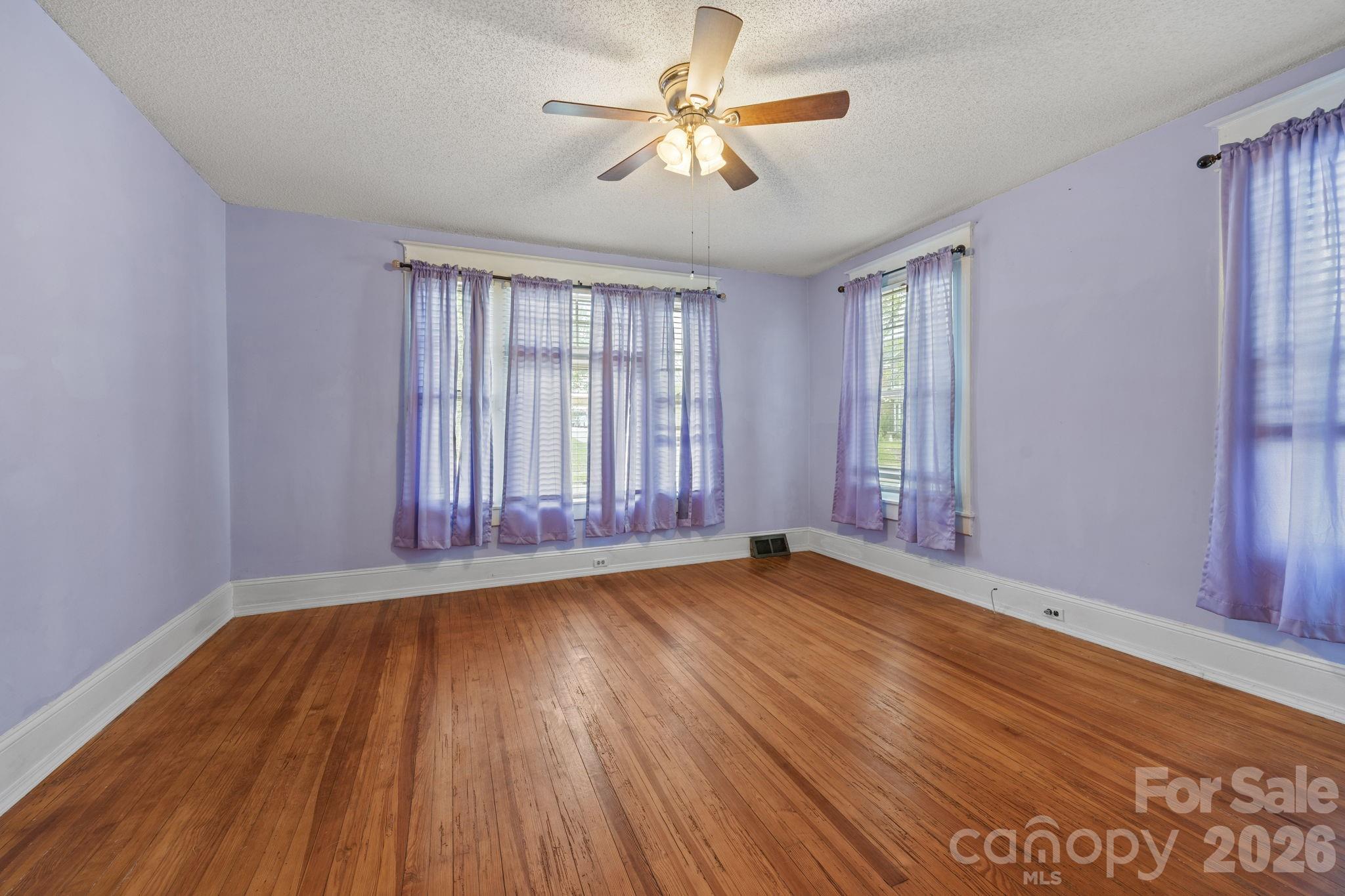 628 West Council Street Salisbury, NC 28144 - Photo 27 of 43 an empty room with wooden floor and windows