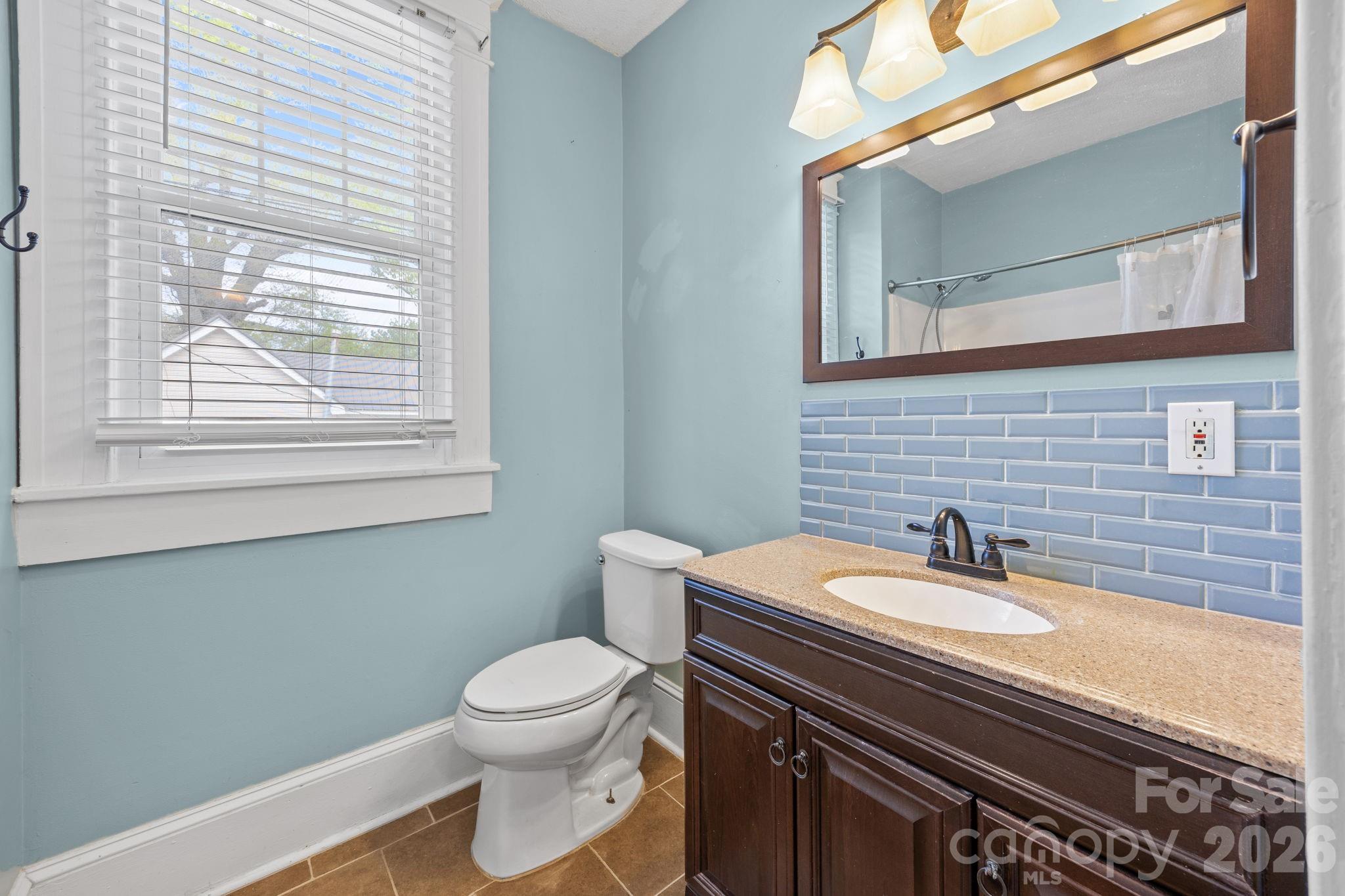 628 West Council Street Salisbury, NC 28144 - Photo 28 of 43 a bathroom with a sink a toilet and a mirror