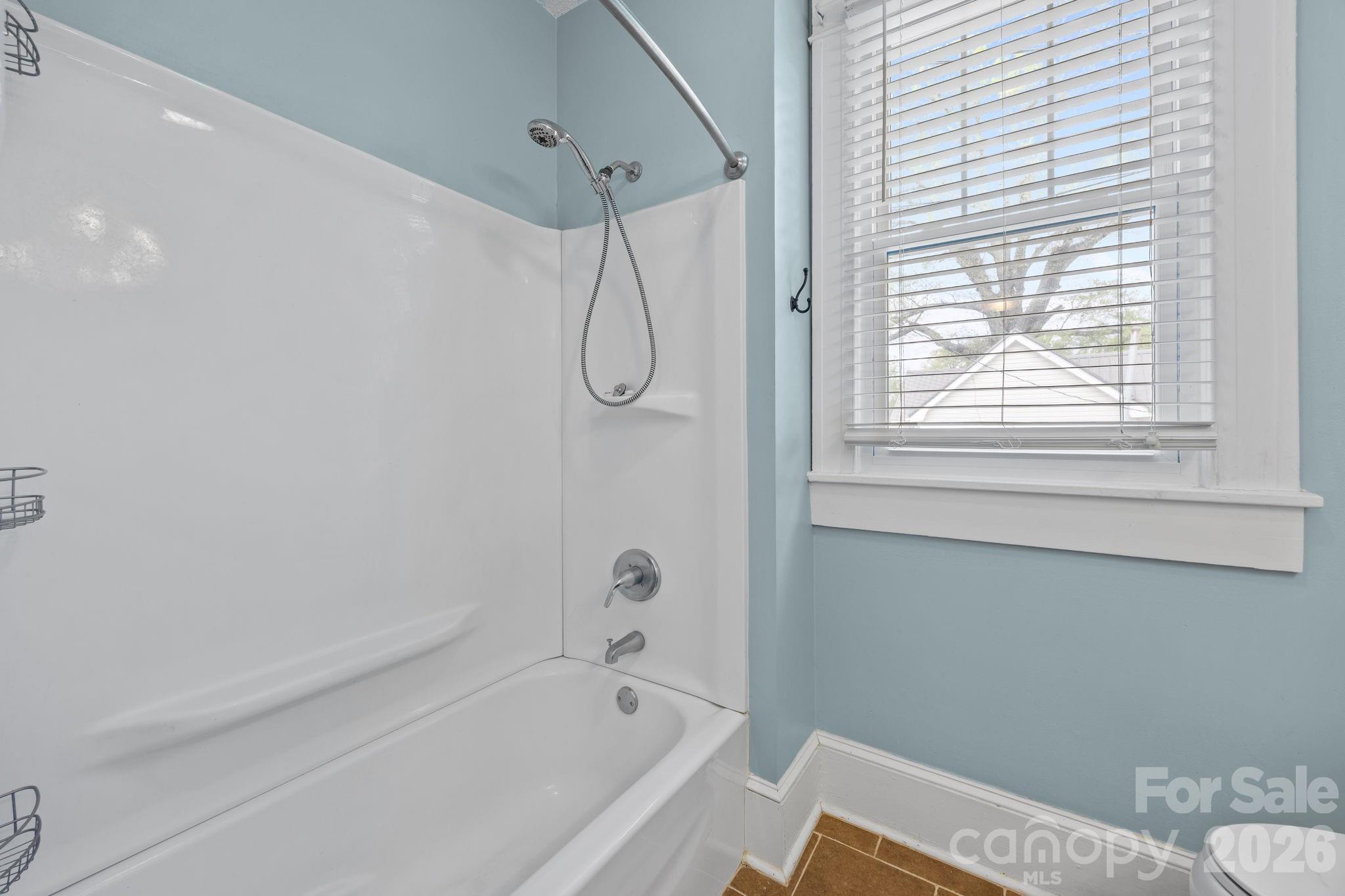 628 West Council Street Salisbury, NC 28144 - Photo 29 of 43 a bathroom with a window and a bathtub