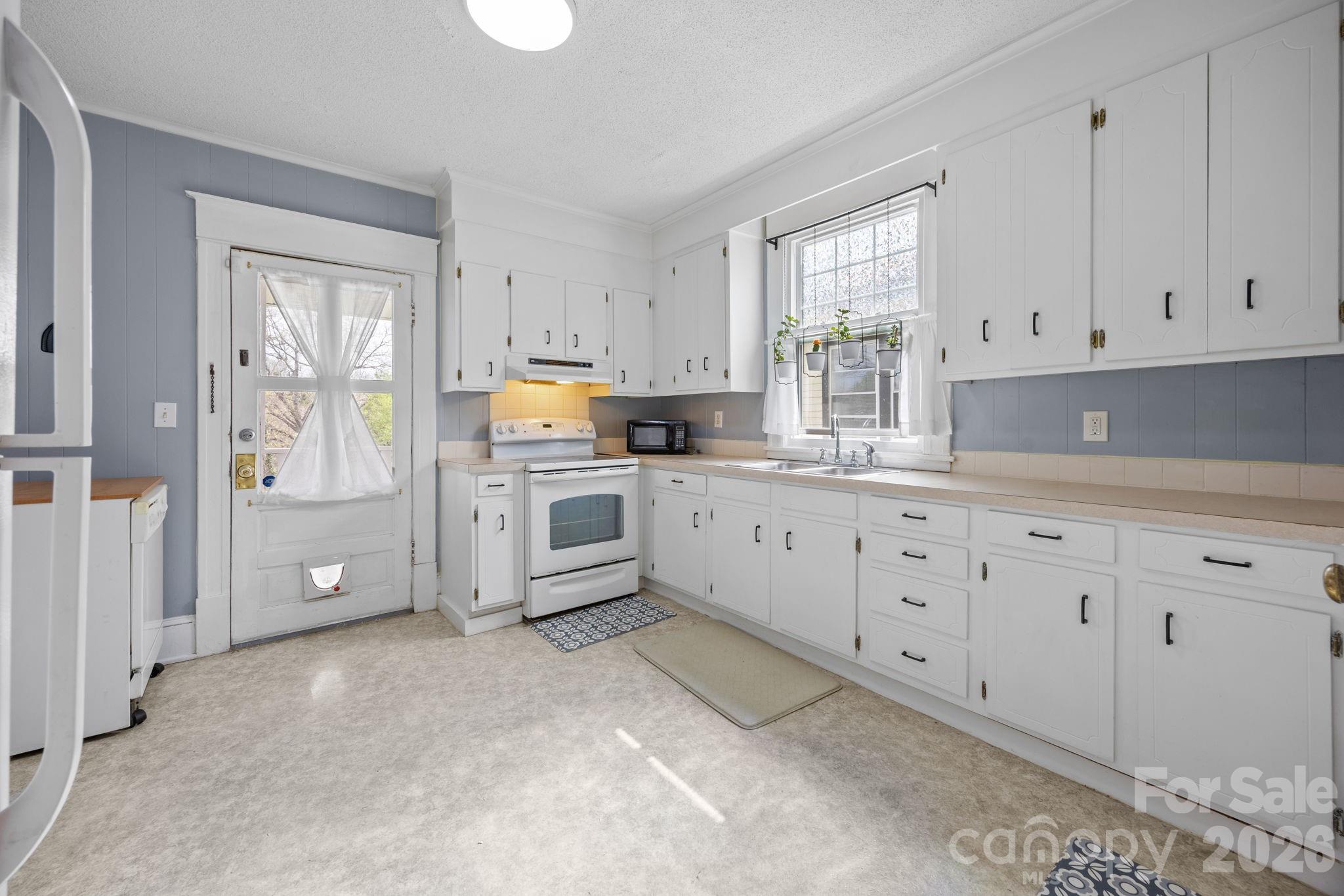 628 West Council Street Salisbury, NC 28144 - Photo 36 of 43 a kitchen with white cabinets and window