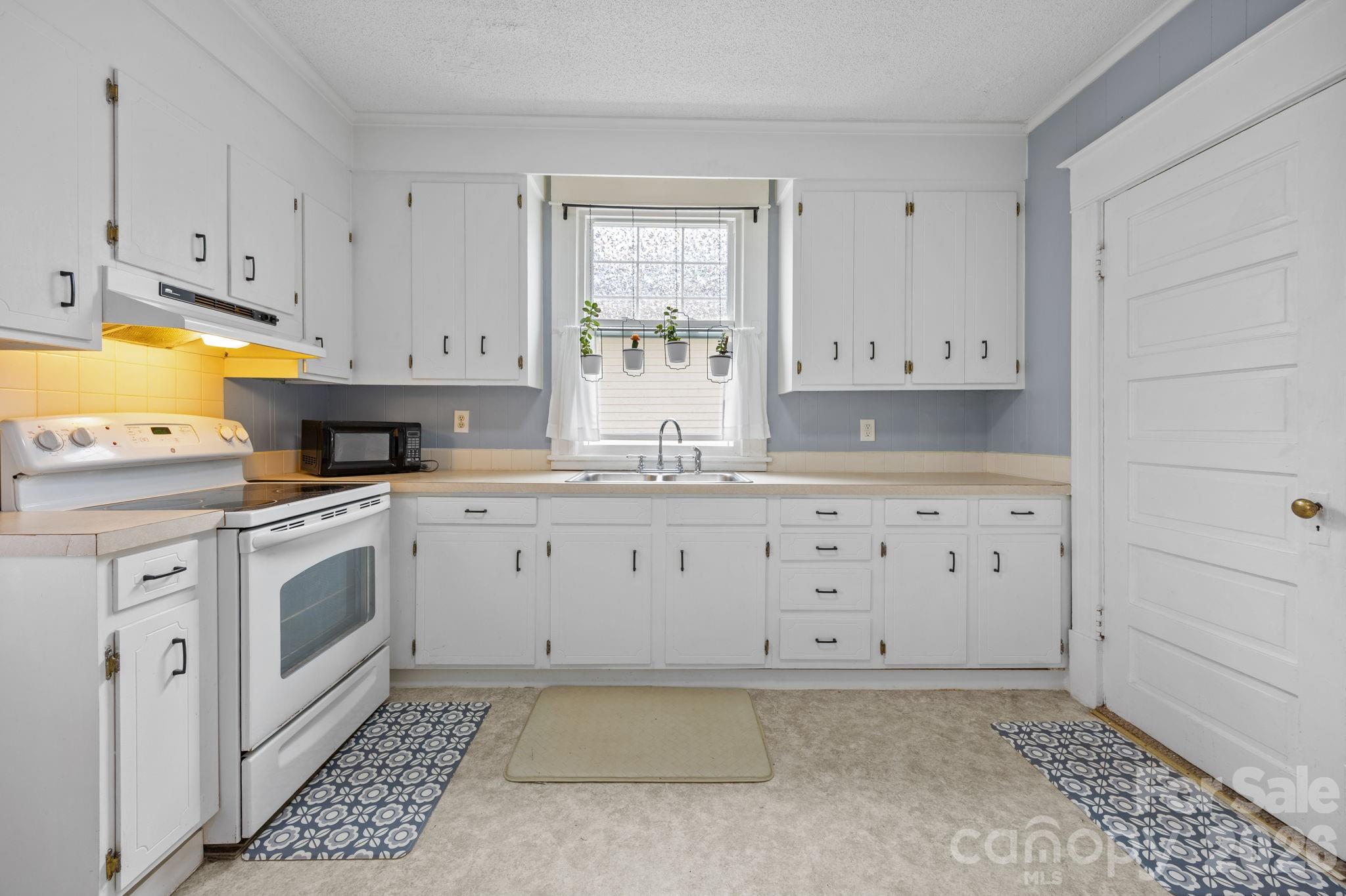 628 West Council Street Salisbury, NC 28144 - Photo 38 of 43 a kitchen with granite countertop white cabinets white stainless steel appliances with a sink and dishwasher