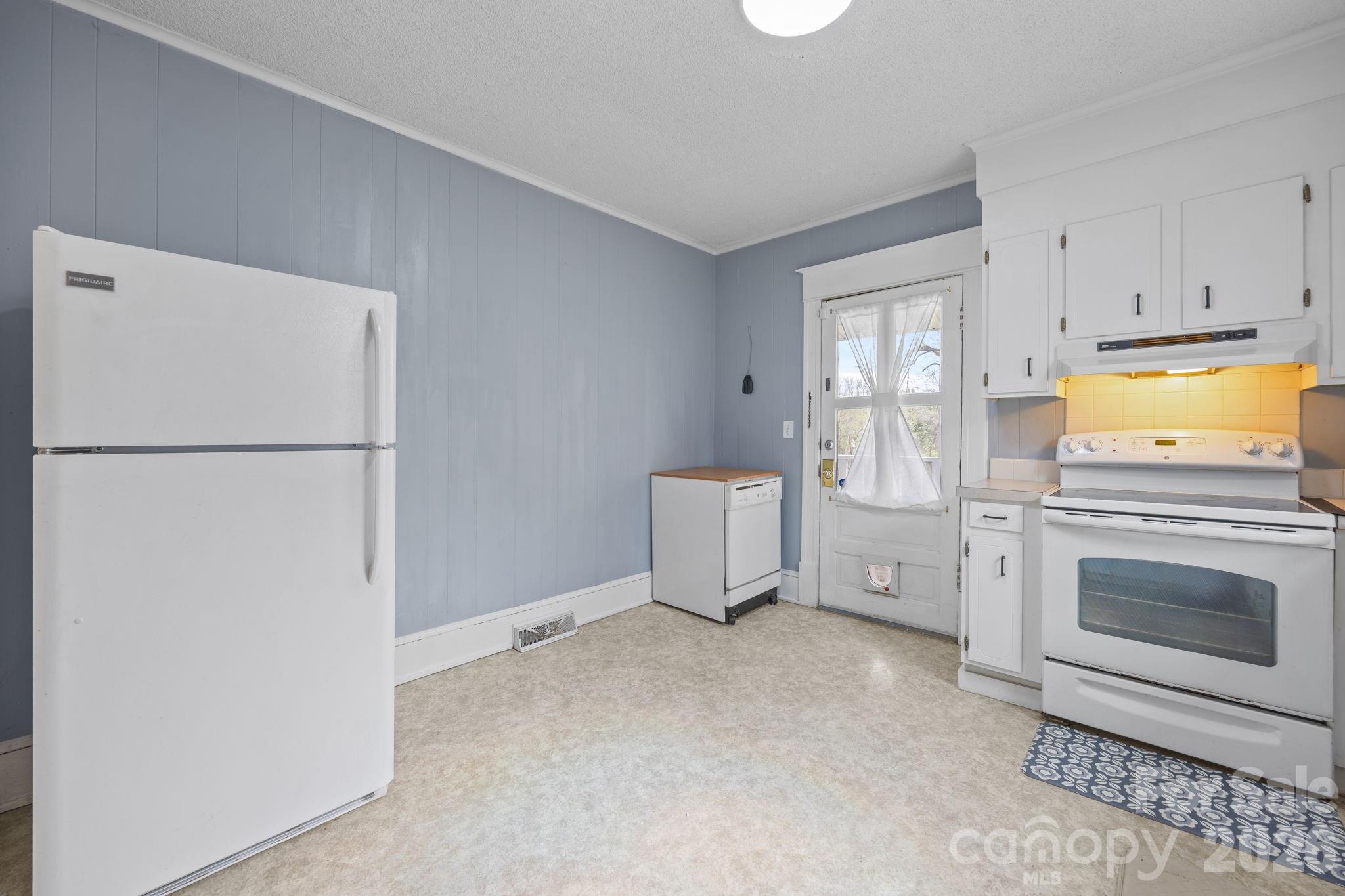 628 West Council Street Salisbury, NC 28144 - Photo 41 of 43 a kitchen with a refrigerator sink stove and cabinets