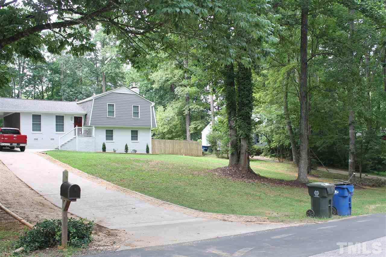 4401 Pike Road Raleigh, NC 27613 - Photo 1 of 14 a front view of a house with a garden and trees