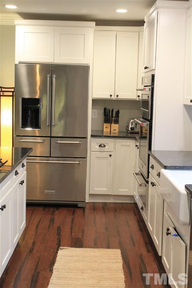 4401 Pike Road Raleigh, NC 27613 - Photo 3 of 14 a kitchen with wooden floors and white appliances