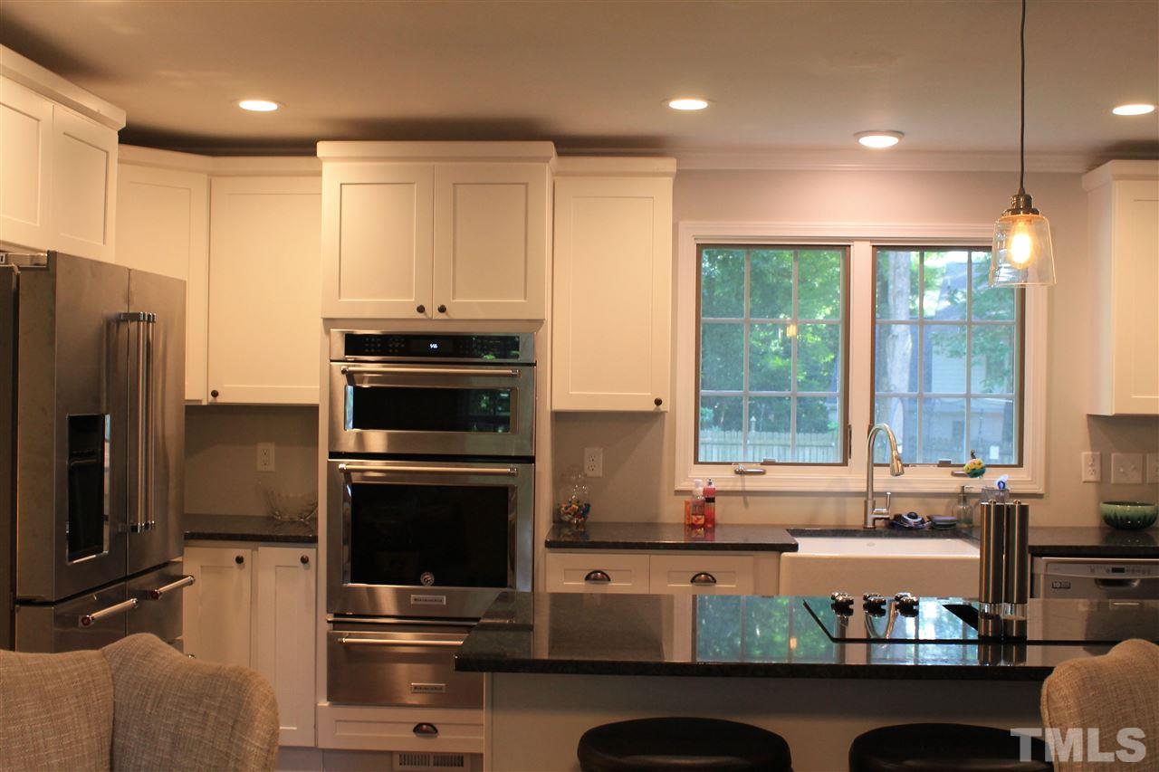 4401 Pike Road Raleigh, NC 27613 - Photo 4 of 14 a kitchen with stainless steel appliances granite countertop a refrigerator a sink and a stove
