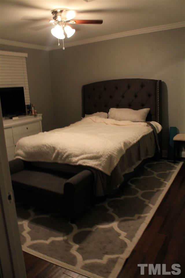 4401 Pike Road Raleigh, NC 27613 - Photo 8 of 14 a bedroom with a bed and a flat tv screen