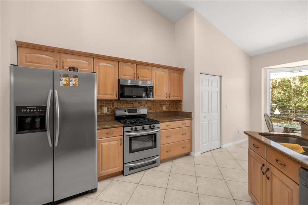 19040 Northwest 88th Avenue Road Reddick, FL 32686 - Photo 13 of 68 a kitchen with stainless steel appliances granite countertop a refrigerator stove and sink