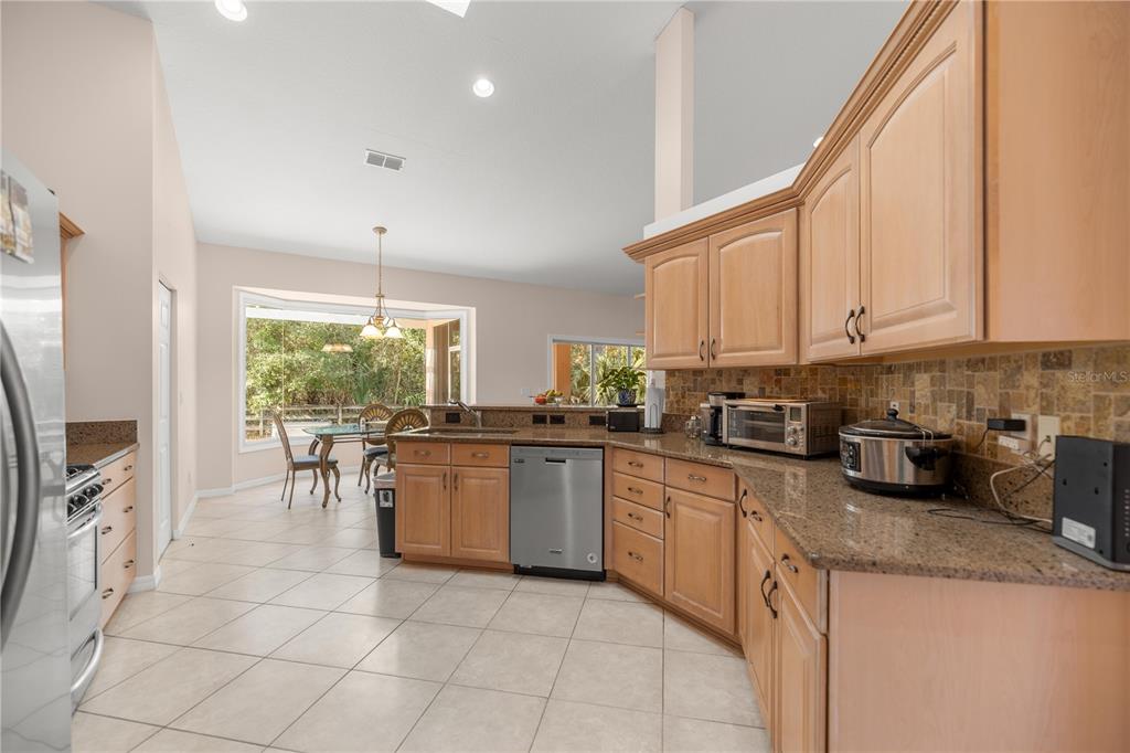 19040 Northwest 88th Avenue Road Reddick, FL 32686 - Photo 14 of 68 a kitchen with a sink a counter top space appliances and cabinets