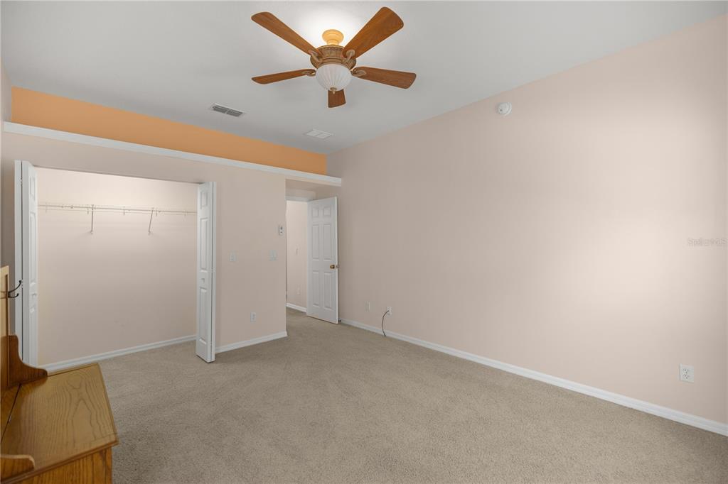 19040 Northwest 88th Avenue Road Reddick, FL 32686 - Photo 26 of 68 an empty room with closet and fan