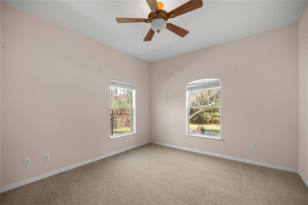 19040 Northwest 88th Avenue Road Reddick, FL 32686 - Photo 27 of 68 an empty room with windows and fan