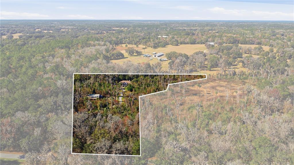 19040 Northwest 88th Avenue Road Reddick, FL 32686 - Photo 66 of 68 an aerial view of residential houses with outdoor space