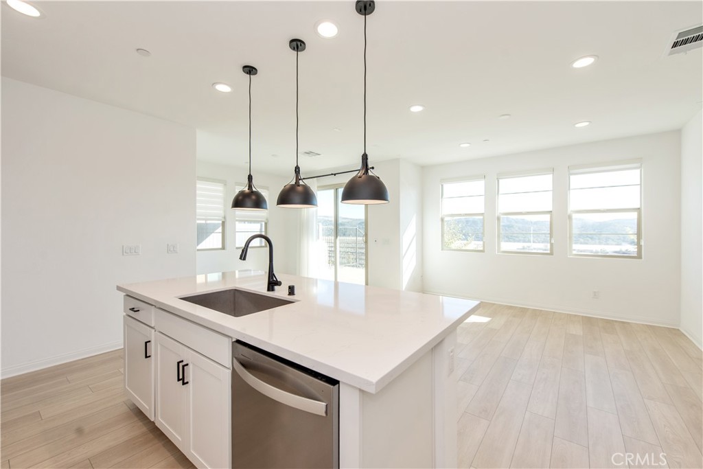781 Cornelia Way Rancho Mission Viejo, CA 92694 - Photo 12 of 24 a kitchen with kitchen island a sink appliances and a counter space