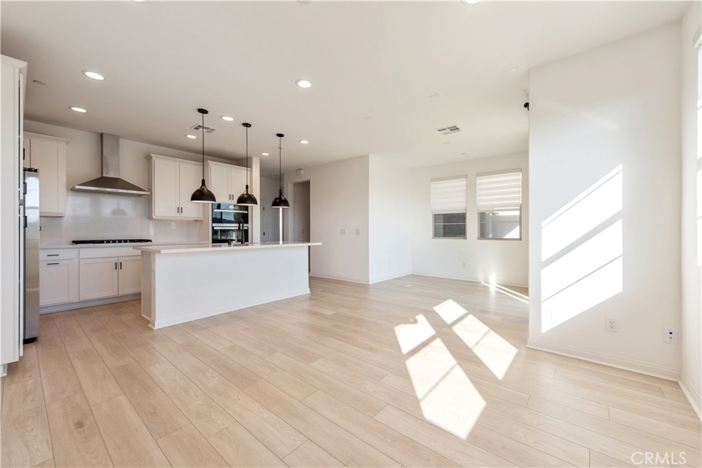 781 Cornelia Way Rancho Mission Viejo, CA 92694 - Photo 9 of 24 a view of kitchen with kitchen island white cabinets and stainless steel appliances