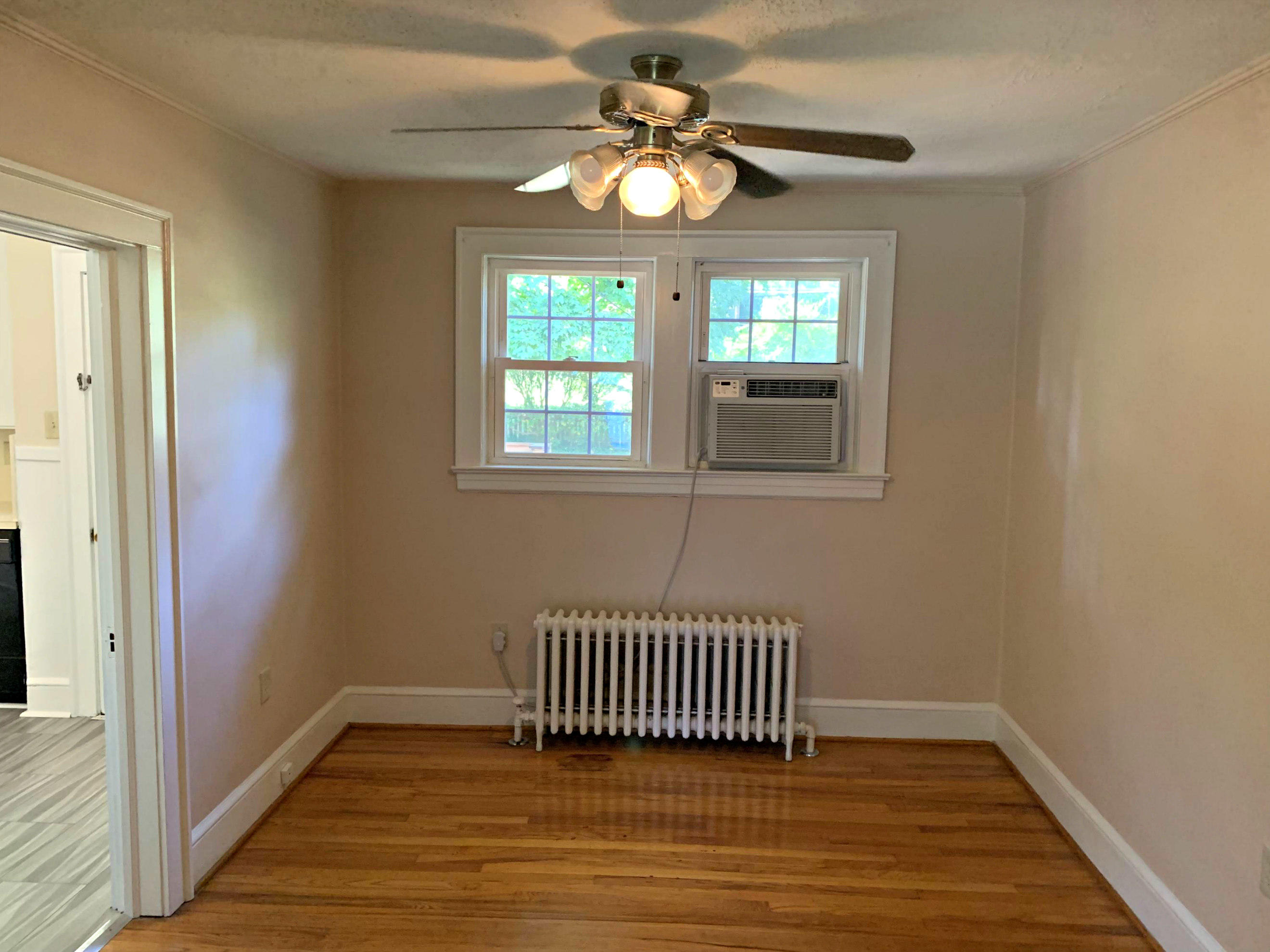1668 Brandon Avenue Southwest Roanoke, VA 24015 - Photo 11 of 24 a view of empty room with a window and wooden floor