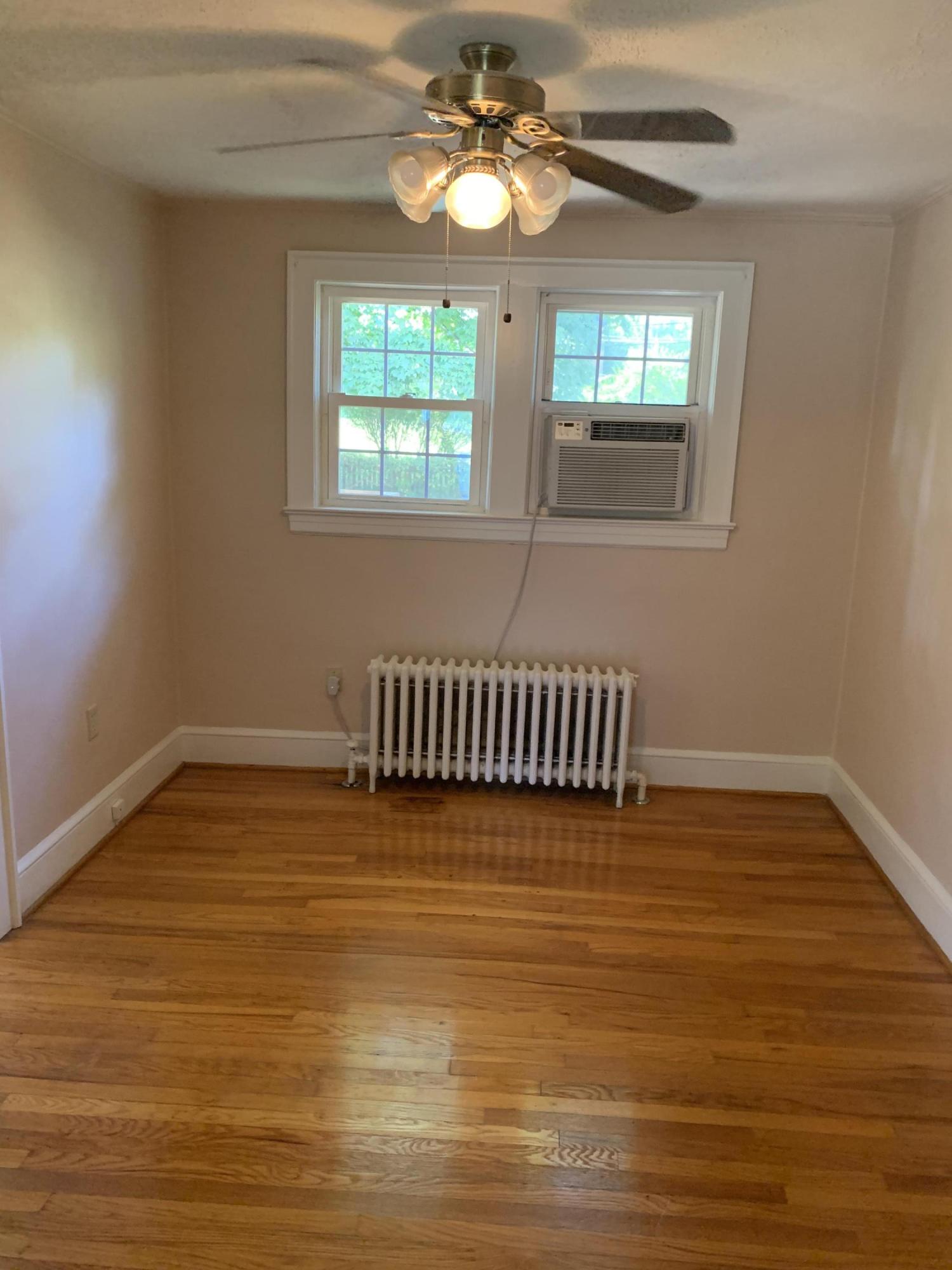 1668 Brandon Avenue Southwest Roanoke, VA 24015 - Photo 12 of 24 a view of a room with wooden floor and chandelier