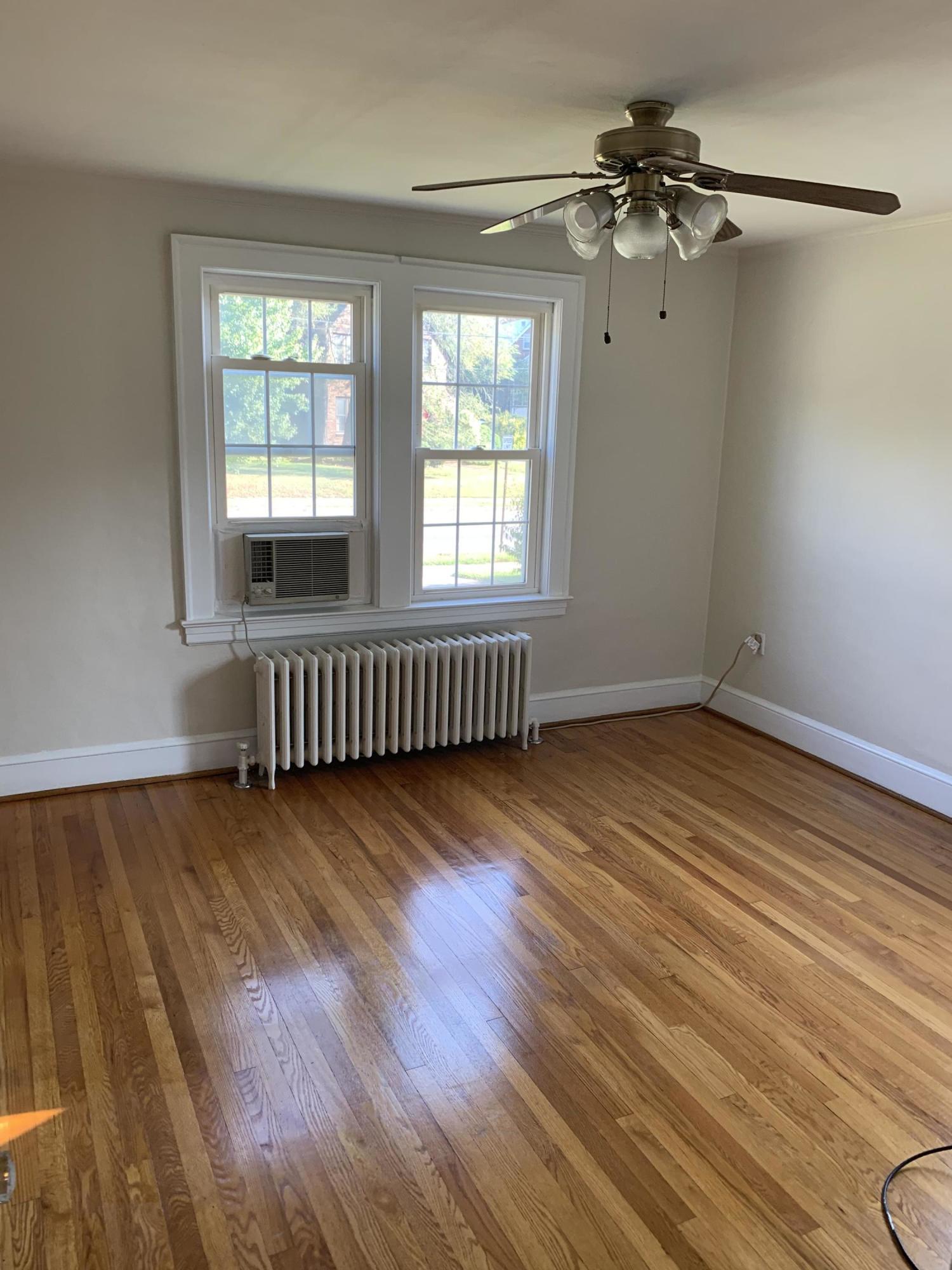 1668 Brandon Avenue Southwest Roanoke, VA 24015 - Photo 14 of 24 an empty room with wooden floor fan and windows