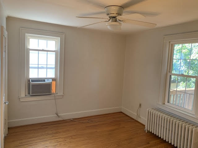 1668 Brandon Avenue Southwest Roanoke, VA 24015 - Photo 15 of 24 an empty room with wooden floor fan and windows