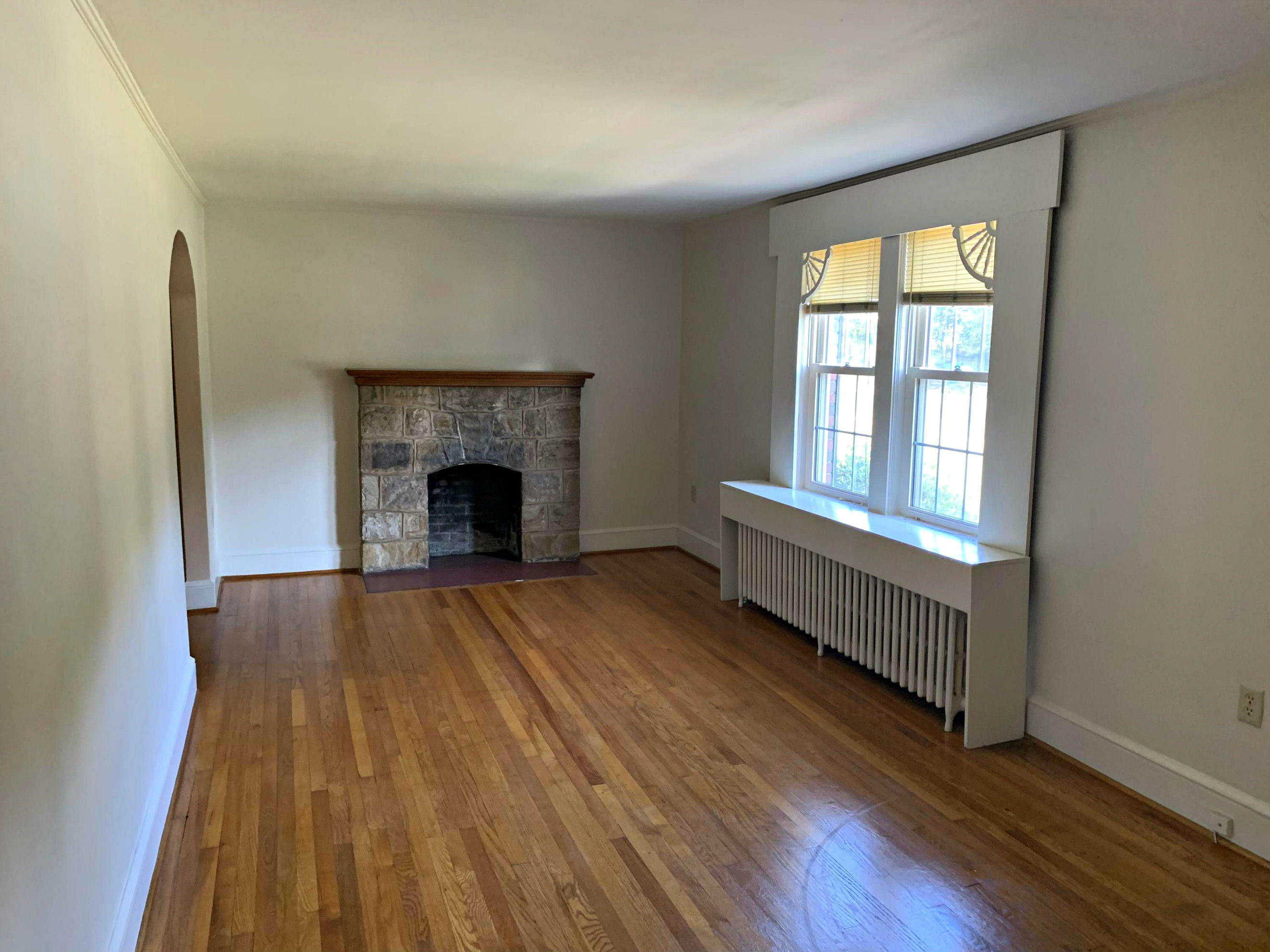 1668 Brandon Avenue Southwest Roanoke, VA 24015 - Photo 6 of 24 wooden floor fireplace and windows in an empty room