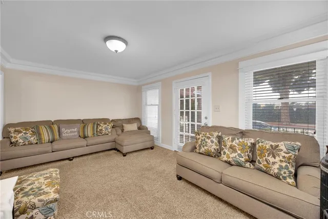 a living room with furniture a couch and large window