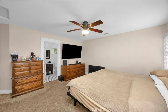 a bed room with a bed a television and a couch