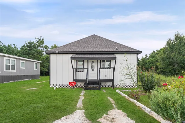 a front view of a house with a yard and porch