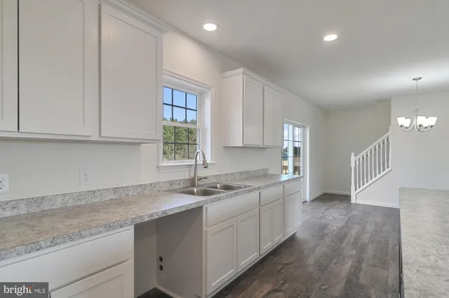 a kitchen with a sink cabinets and window