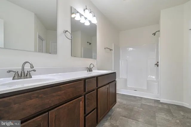 a bathroom with a sink vanity and a mirror