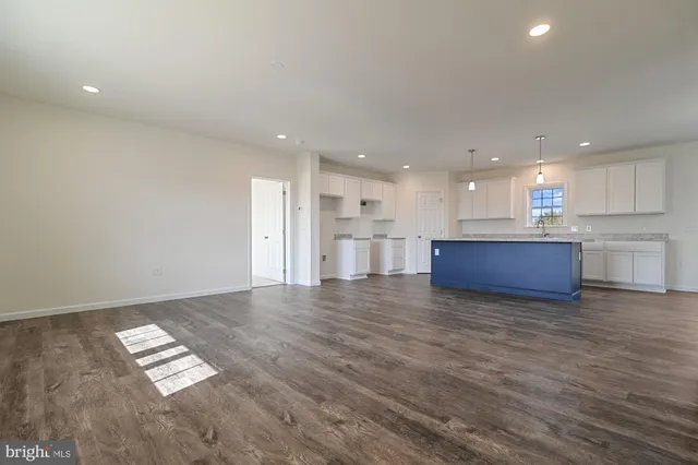 a view of kitchen with kitchen island and wooden floor