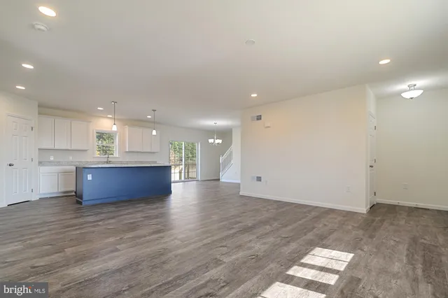 a view of kitchen with kitchen island and wooden floor
