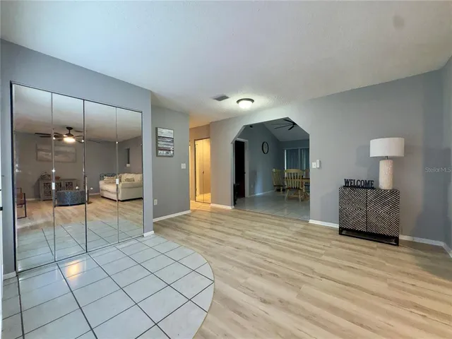 a bedroom with a bed and a mirror