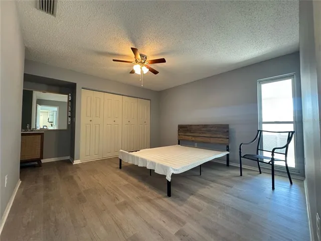 a bathroom with a granite countertop toilet sink and mirror
