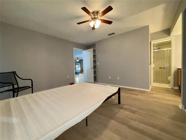 a living room with furniture a flat screen tv and a table