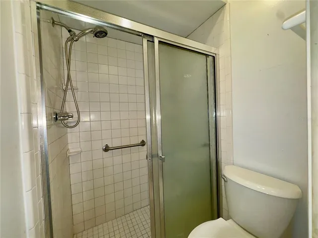 a bathroom with a shower and a toilet