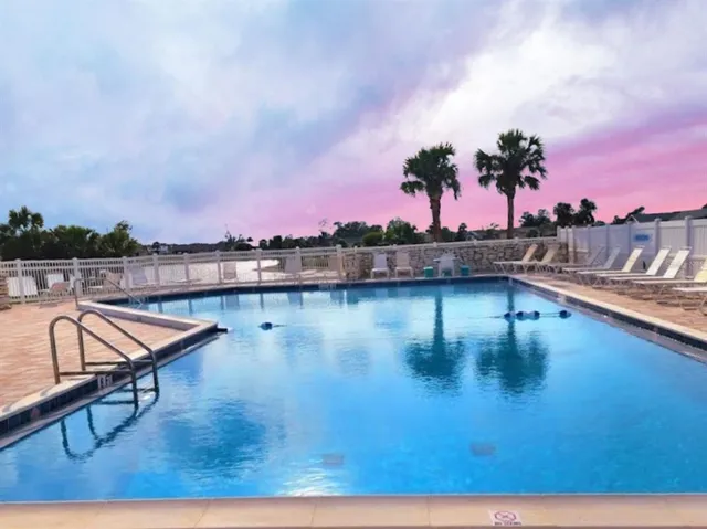 a view of swimming pool with outdoor seating