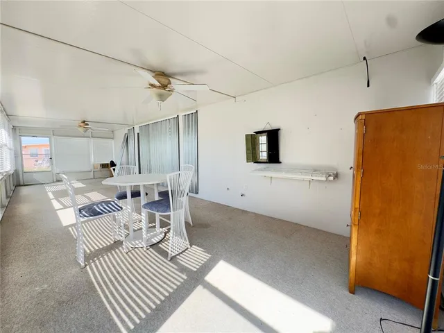 a living room with furniture a flat screen tv and a table