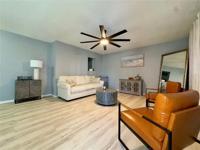 a living room with furniture and a wooden floor