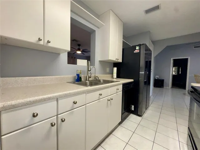 a kitchen with a sink and cabinets