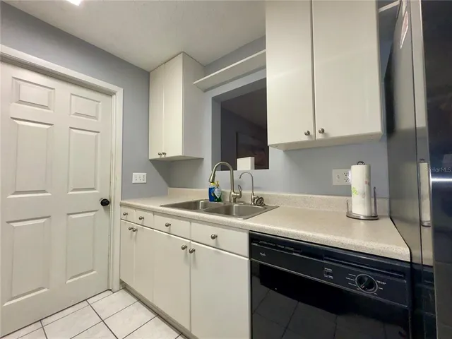 a dining room with furniture and a chandelier fan