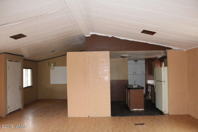 895 South Tanner Lane Snowflake, AZ 85937 - Photo 13 of 32 a view of a refrigerator in kitchen and an empty room