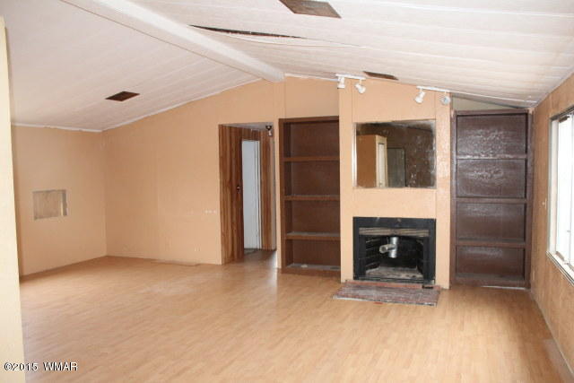895 South Tanner Lane Snowflake, AZ 85937 - Photo 14 of 32 an empty room with fireplace and window