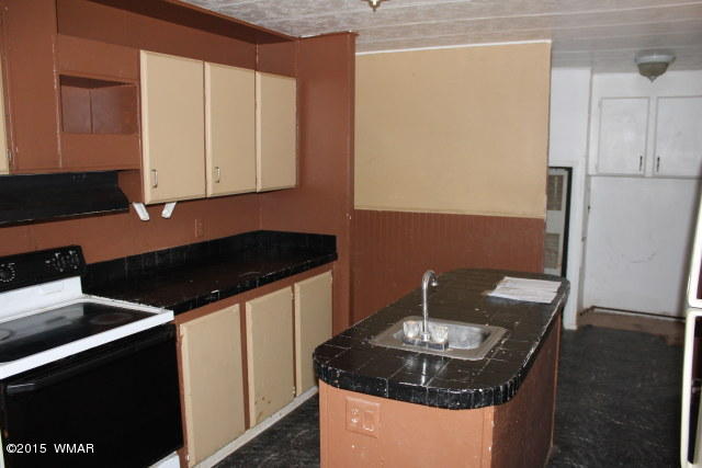 895 South Tanner Lane Snowflake, AZ 85937 - Photo 19 of 32 a kitchen with a sink and a stove top oven