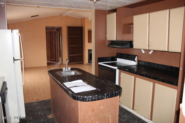 895 South Tanner Lane Snowflake, AZ 85937 - Photo 20 of 32 a kitchen with granite countertop a sink and a stove next to a window