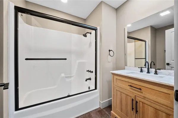 a bathroom with a double vanity sink mirror and shower