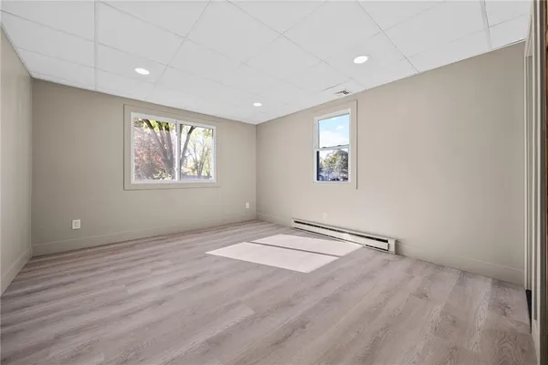 an empty room with windows and closet