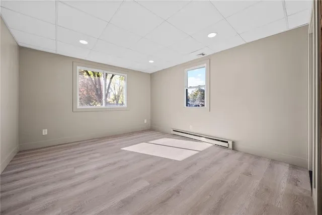 an empty room with windows and closet