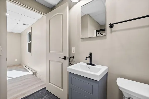 a bathroom with a sink a toilet and shower