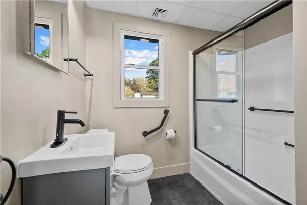a bathroom with a sink toilet and shower